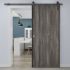 puerta corredera gris laminada lisa instalada en una habitacion moderna