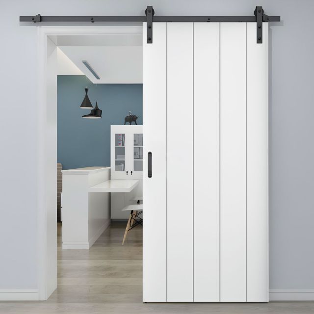puerta corredera de granero blanca instalada en una habitacion moderna que tiene un suelo de madera